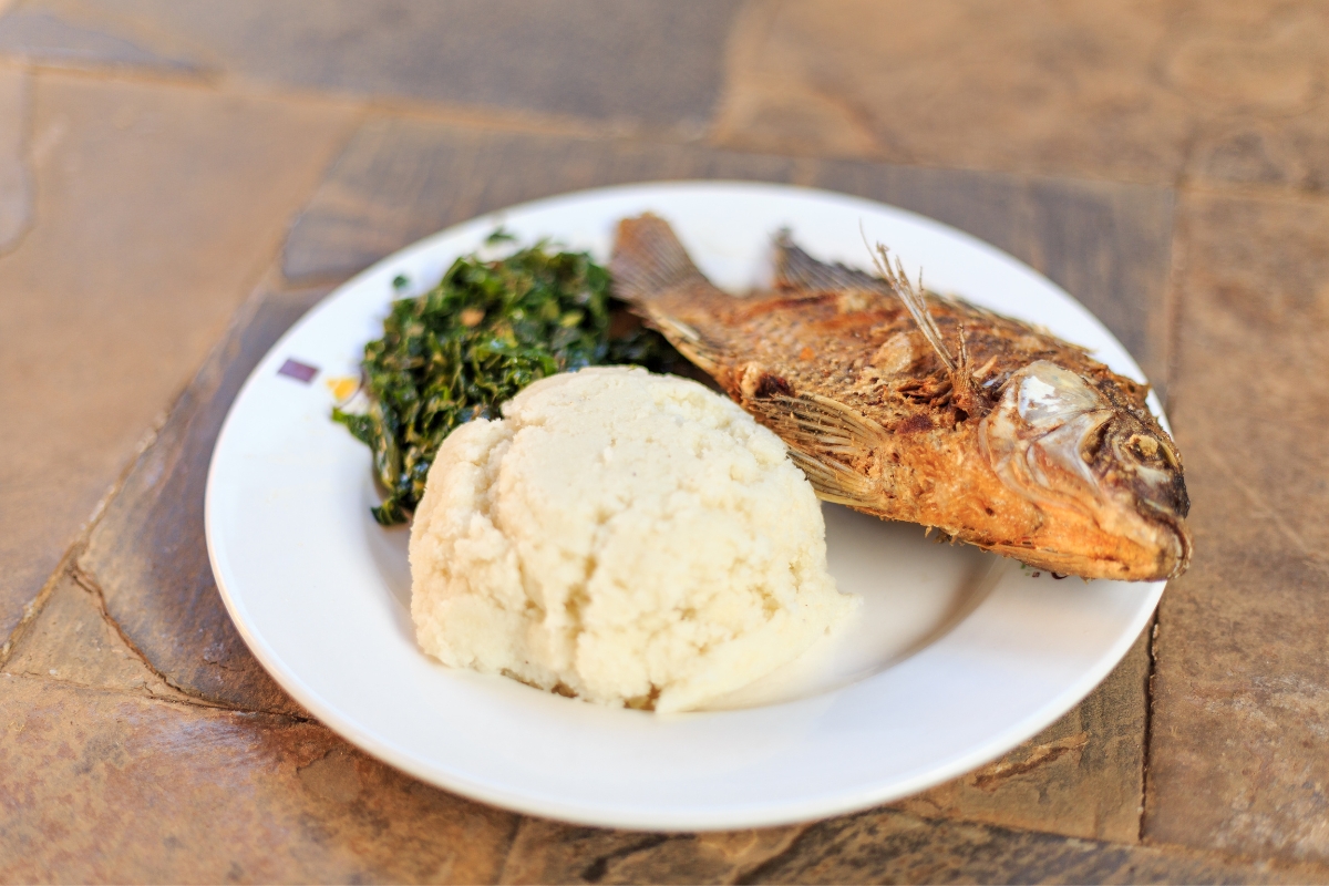Traditional African food - ugali, fish and greens
